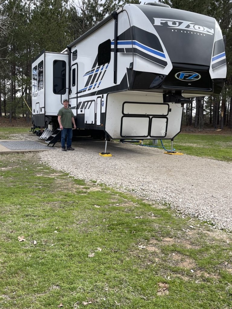 Clay Buckley of RV Tech Services standing in front of an RV